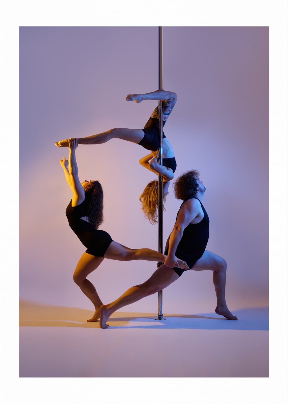 Trio pose at the pole in the Pole Lounge studio