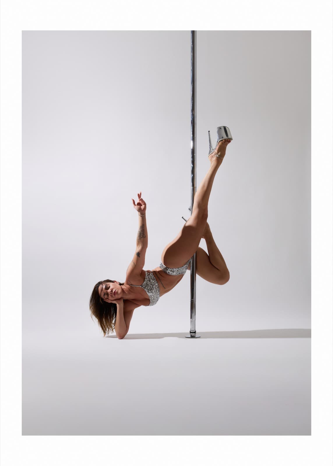 Shardelle in a floorwork pose at the pole