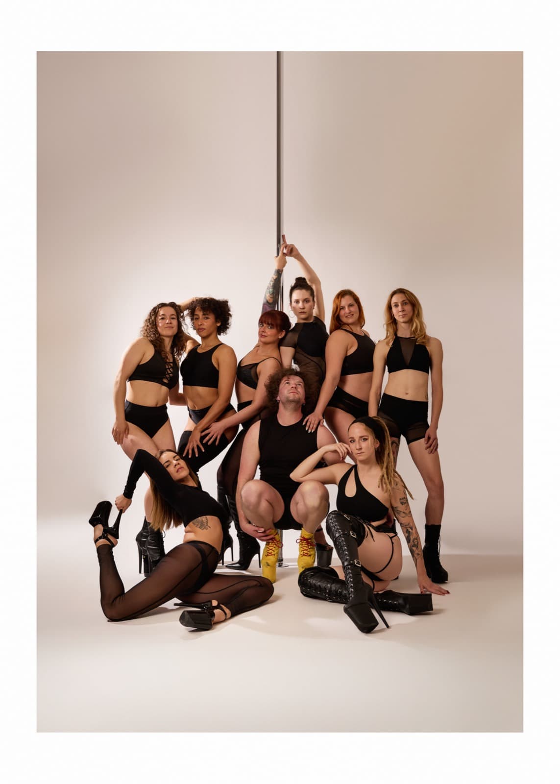 The Pole Lounge team posing around the pole